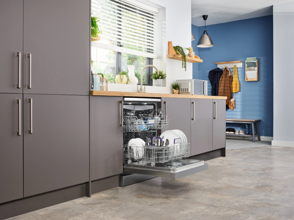 Beko 16 Place Stainless Steel Dishwasher integrated into kitchen cabinets with door open and dishes inside