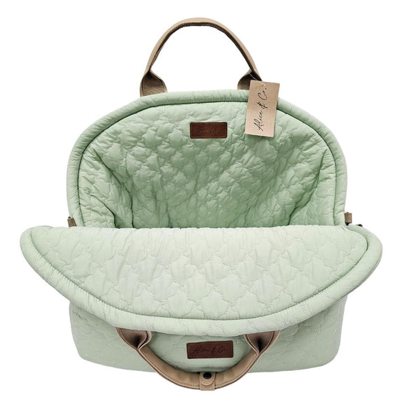 Lottie Travel Bag in pastel sage green with quilted design, leather straps, soft cushion, and safety clip by Keans
