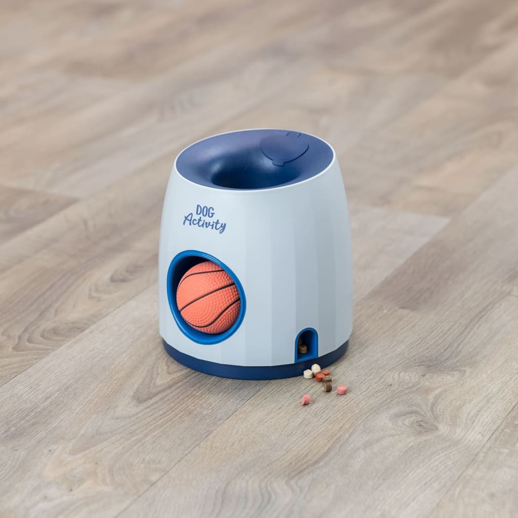 Trixie Treat Strategy Dispenser with orange ball inside and dog treats dispensed on wooden floor