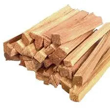 Stack of chopped wooden kindling sticks on a white background.