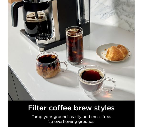 Ninja Prestige DualBrew System with three coffee styles in glass cups and a croissant on a white countertop.