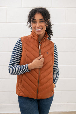 Laurel Ladies Gilet in Rust, water-repellent, sustainable fill, antique brass zip, two zipped pockets - Keans Claremorris