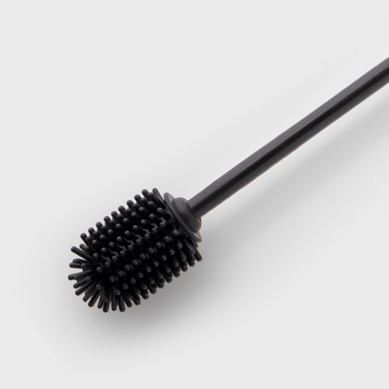 Black silicone bottle brush with flexible bristles and a long handle on a white background.