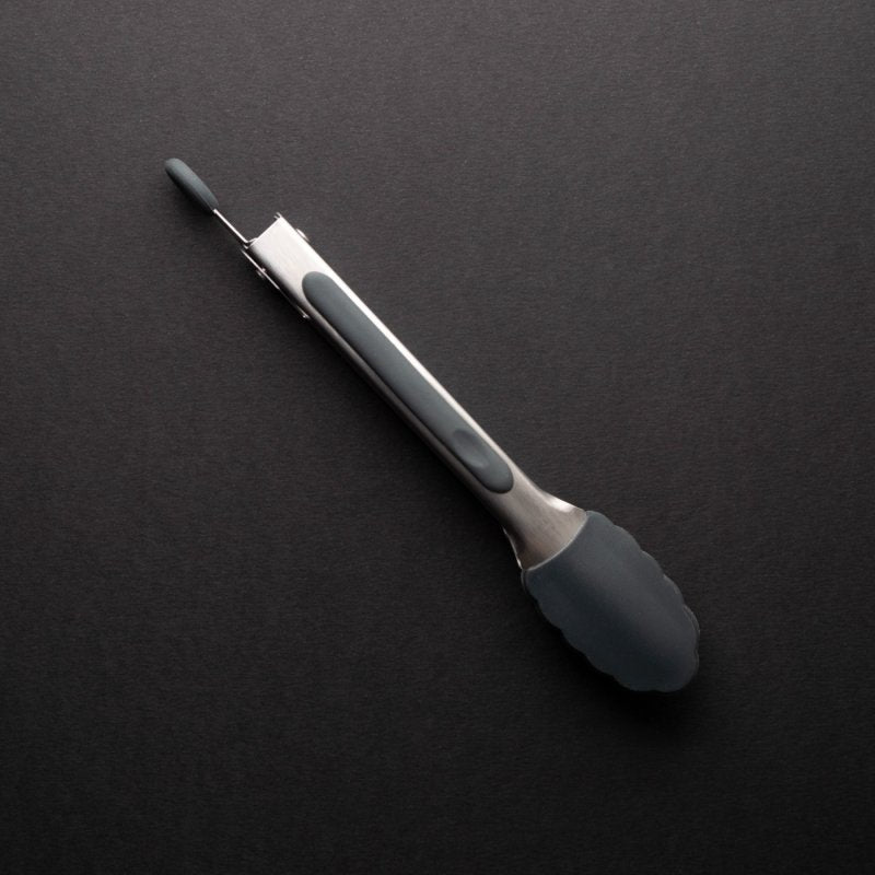 Mini Tongs Graphite with stainless steel body and dark gray silicone tips on a black background.