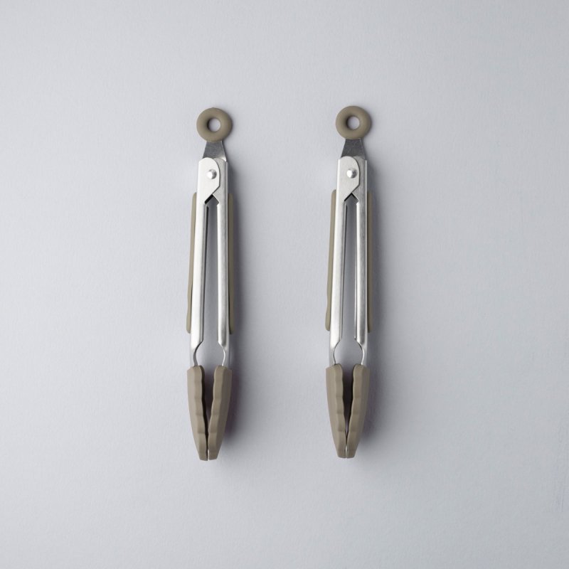 Two grey mini stainless steel tongs with silicone tips, shown closed on a light background.