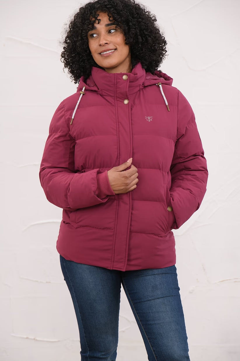 Woman wearing a berry-colored Margot Ladies Coat with a hood and snap button closure, front view.