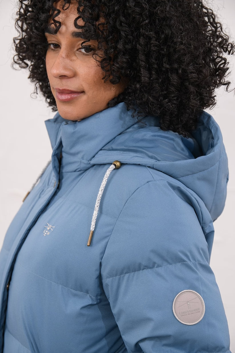 Close-up of Margot Ladies Coat Bluestone showing hood, drawstrings, and sleeve patch detail.