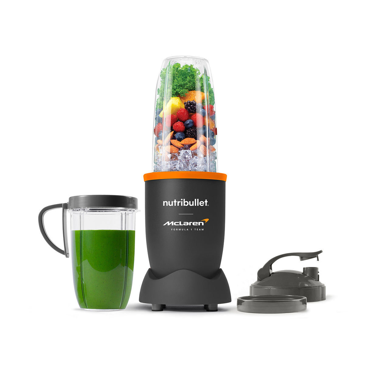 Nutribullet 900 McLaren blender with filled blending cup, green smoothie cup, and two lids on white background