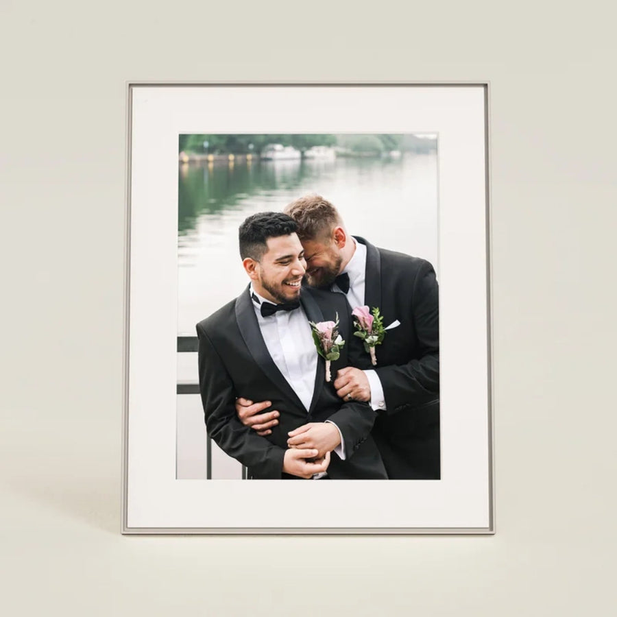Aura Walden 15 Inch Digital Photo Frame in clay with white paper mat showing a wedding photo of two men