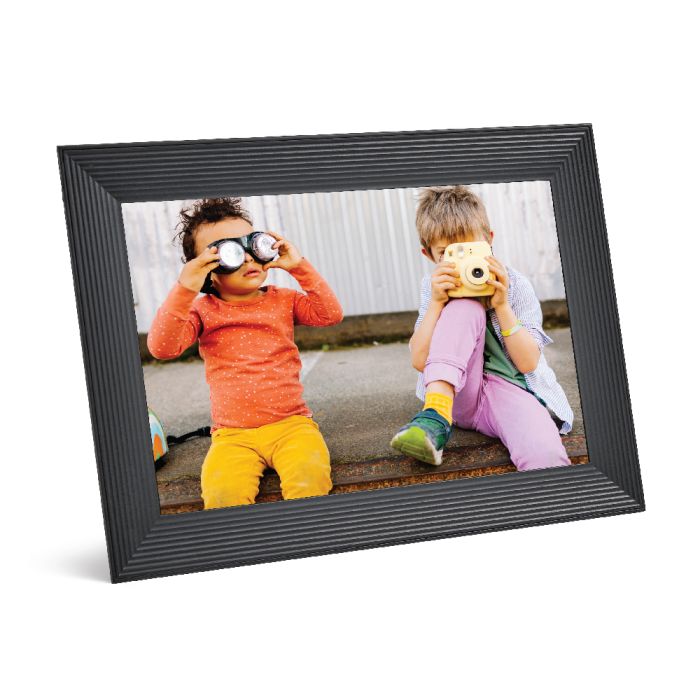 Aura Carver 10.1 inch black digital photo frame displaying a photo of two children playing with cameras.