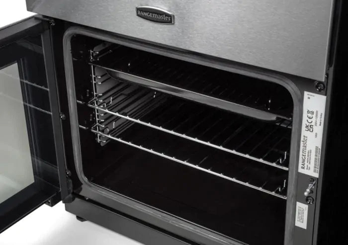 Open stainless steel Rangemaster PROPL60ECSS/C 60cm ceramic cooker oven showing interior racks and door.