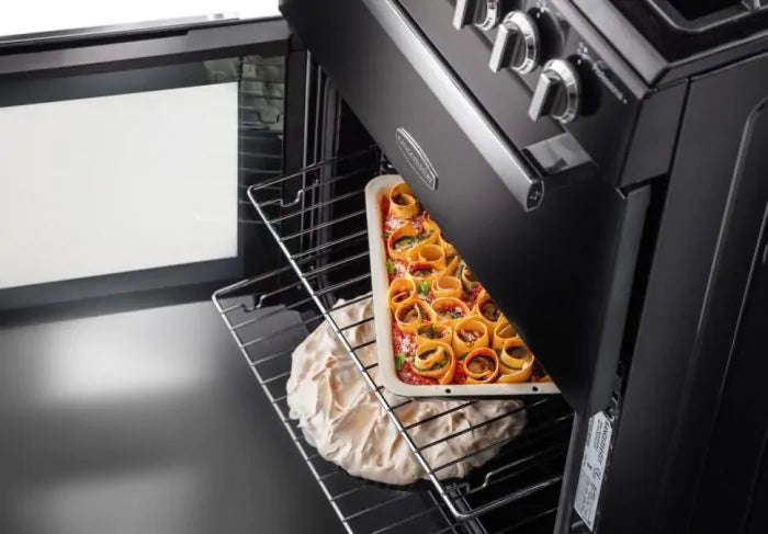 Rangemaster PROPL60ECSS/C stainless steel cooker with oven door open, showing food baking inside