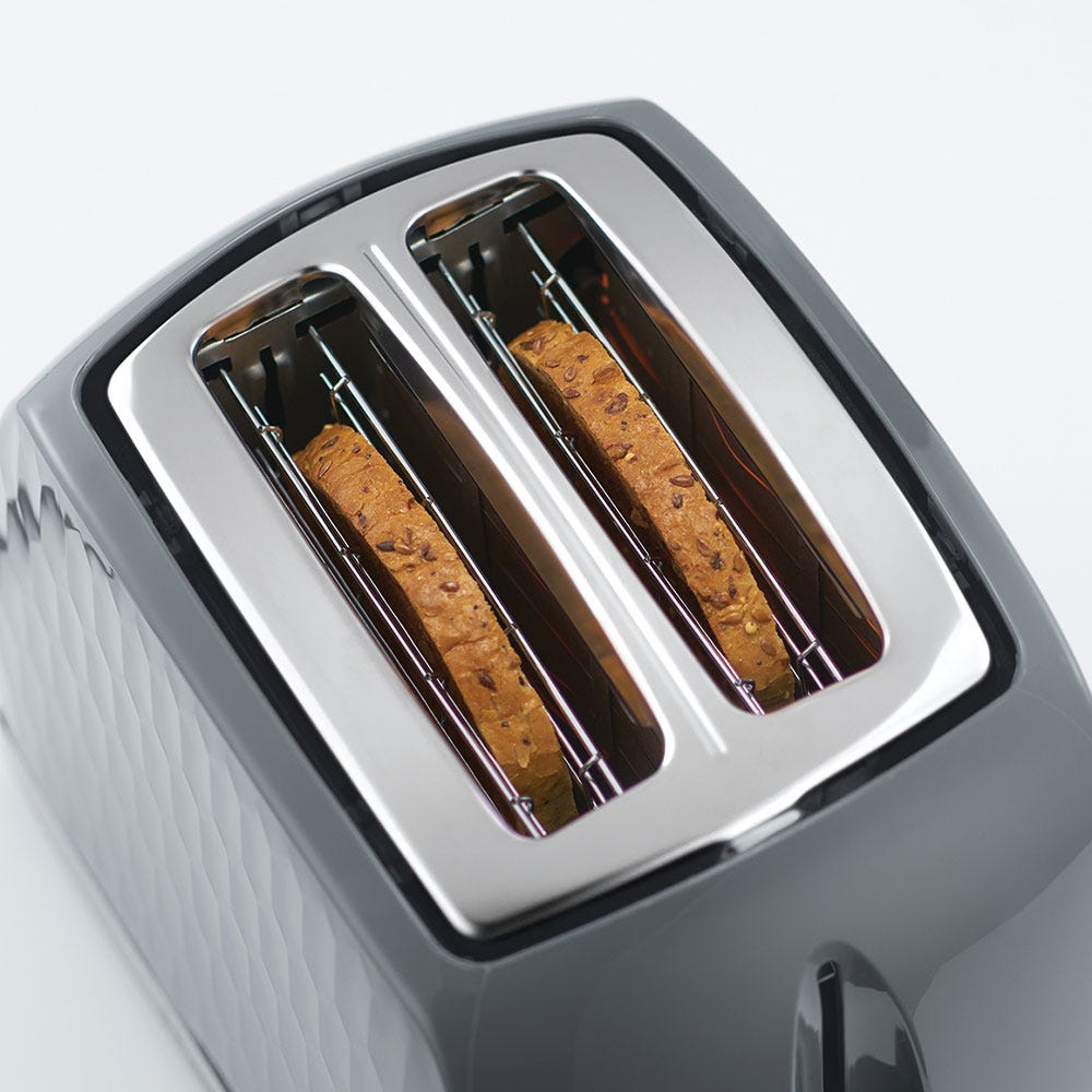 Russell Honeycomb Hobbs grey toaster with two slices of seeded bread inside the extra-wide slots.
