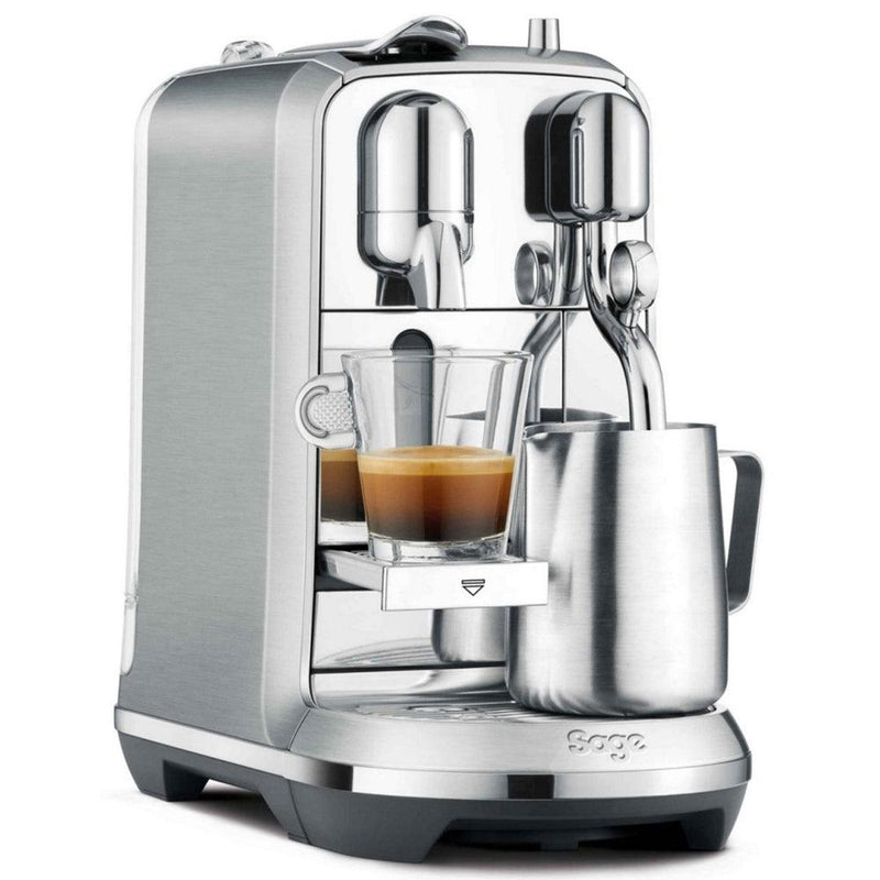 Sage The Creatista Plus Nespresso machine in brushed stainless steel with espresso cup and milk frothing jug.