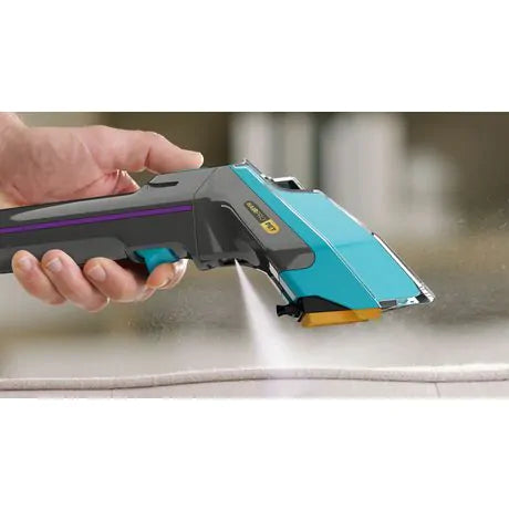 Handheld Shark Carpet Xpert PET PRO spraying cleaning solution onto a carpet surface.
