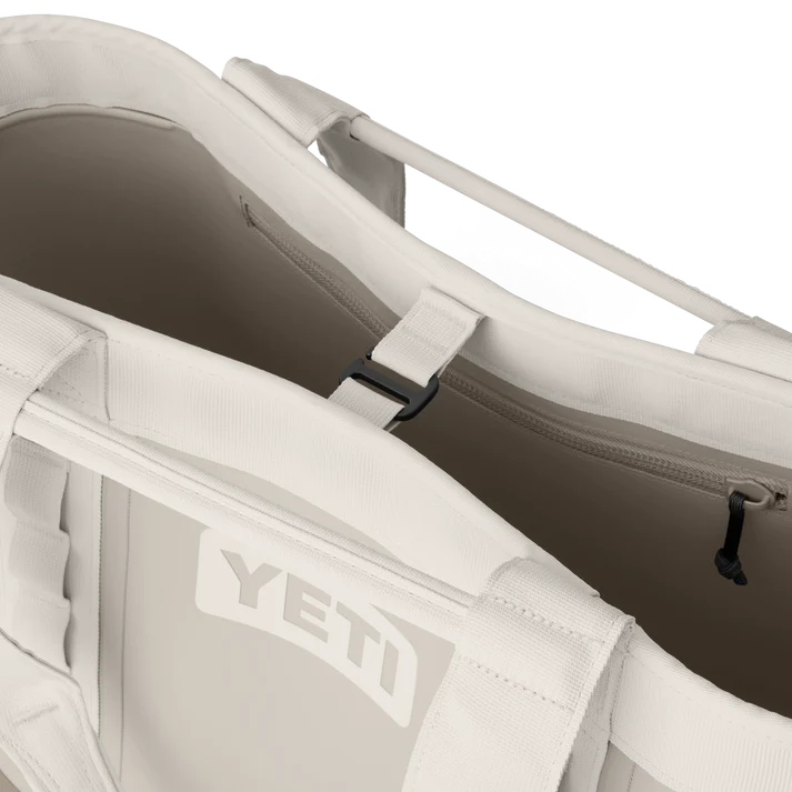 Close-up of the open YETI Camino® Carryall 35 2.0 tote bag in Cape Taupe showing interior and handles.