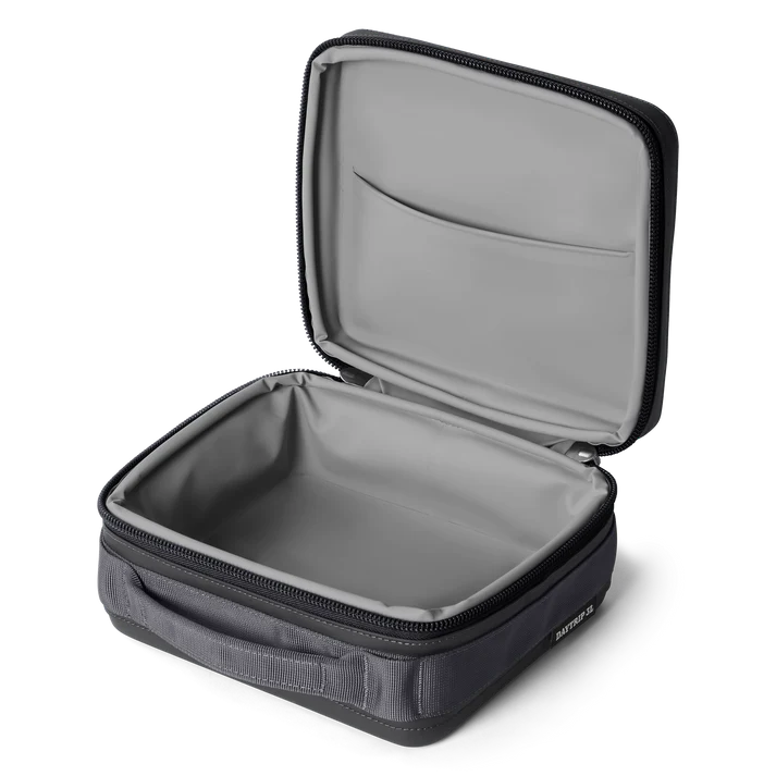 Open Yeti Eu Daytrip insulated lunch box in charcoal showing empty interior and lid pocket.