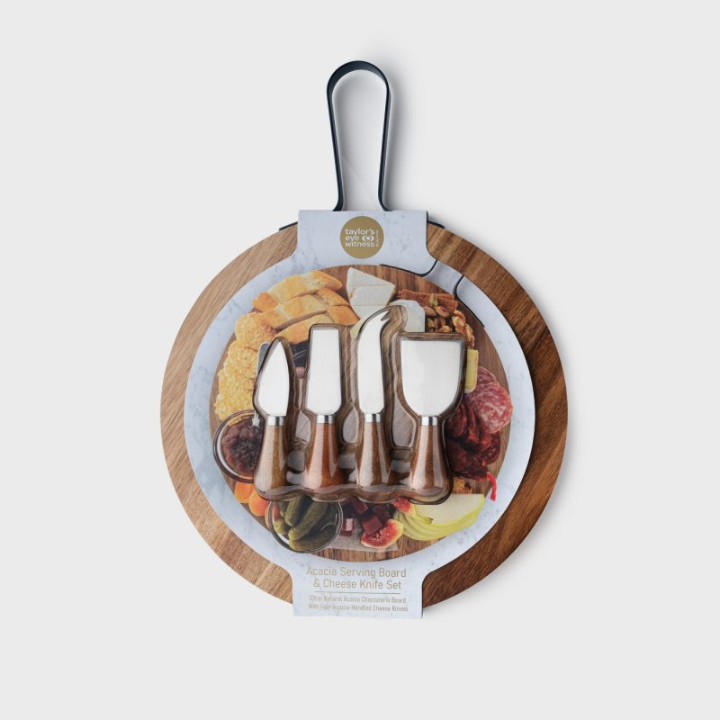 Round acacia wood charcuterie board with four cheese knives in packaging showing serving suggestions.
