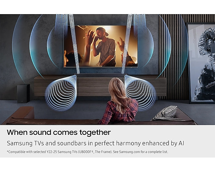 Woman sitting on couch watching TV with Samsung Q600F soundbar and subwoofer emitting 3D sound waves