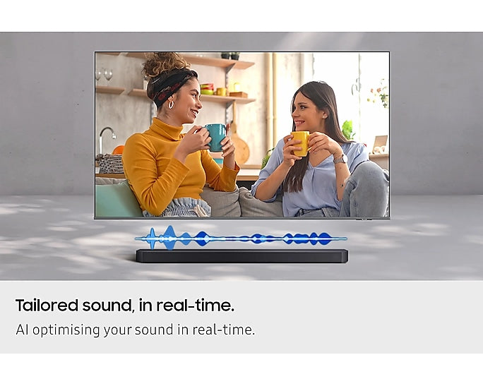 Samsung Q600F soundbar shown below a TV screen with two women chatting and holding mugs.