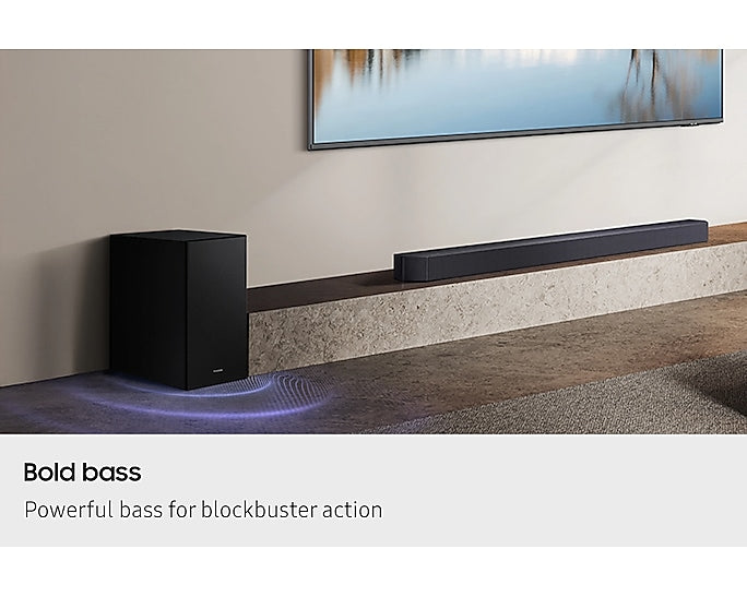 Samsung Q600F soundbar and subwoofer setup below a wall-mounted TV in a modern living room.