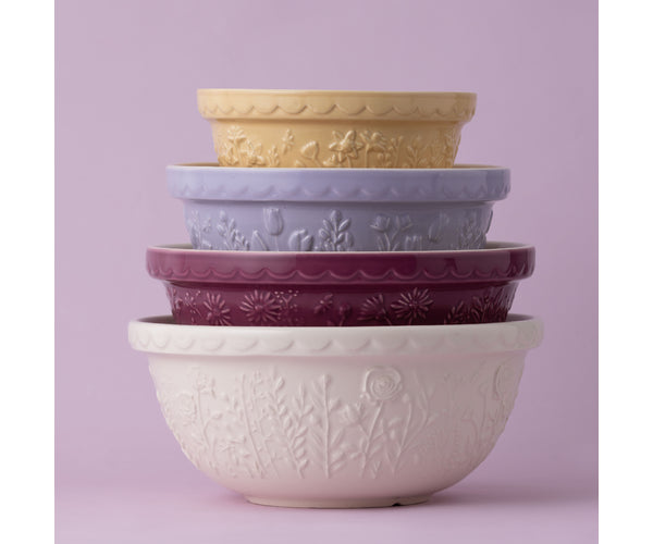 Stacked Tulip Lilac Mixing Bowls in cream, burgundy, lilac, and mustard with floral embossed patterns.
