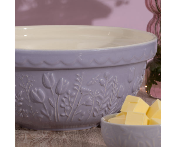 Tulip Lilac Mixing Bowl with embossed floral design in soft purple, shown with a smaller bowl of butter cubes.