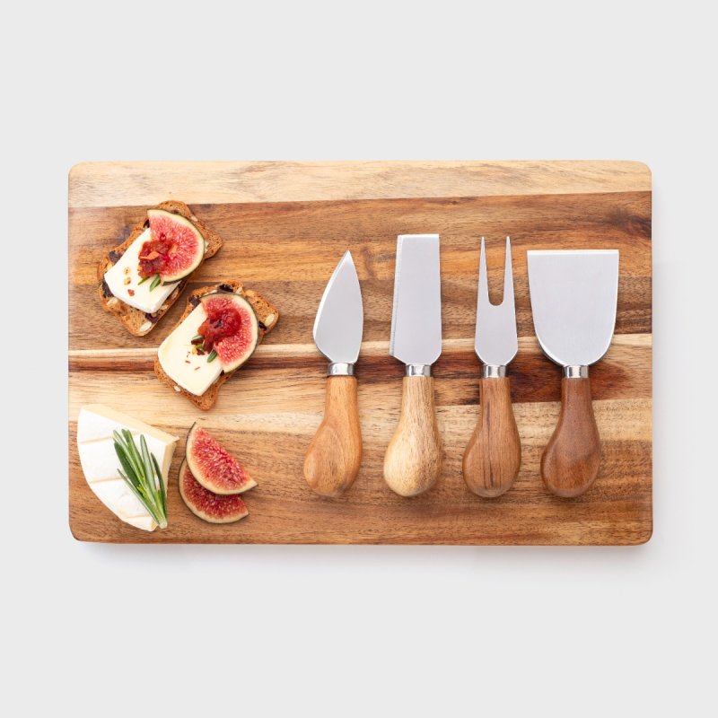4 piece acacia cheese knife set with rectangular board, cheese, figs, and crackers arranged on top