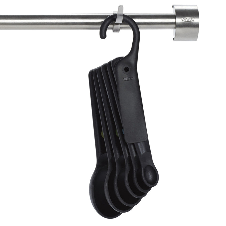 Oxo 7-piece black plastic measuring spoon set with snap ring, available at Keans Claremorris.