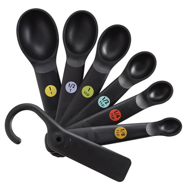 Oxo 7-piece black plastic measuring spoons with non-slip grips, snap-together design, and flat resting base – Keans