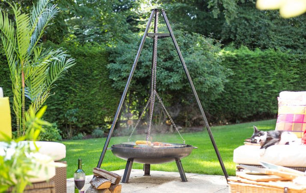 La Hacienda Tripod Hanging Grill with adjustable chrome grill, black steel tripod, fits firepits – available at Keans